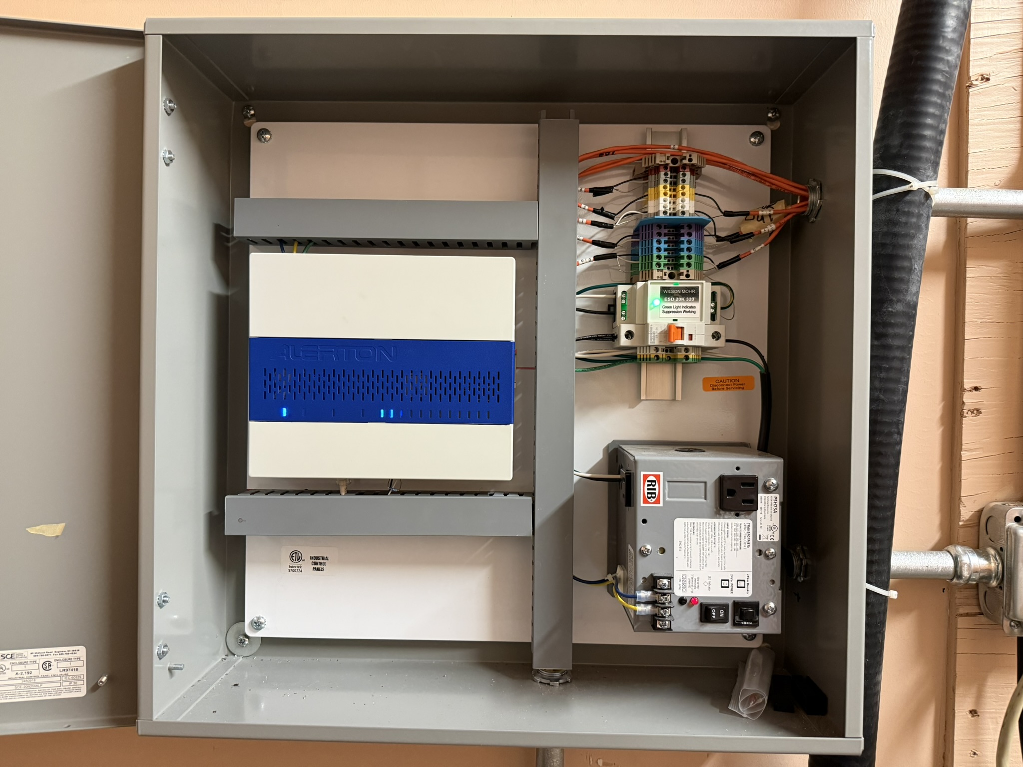 An installed building controls panel with an Alerton controller